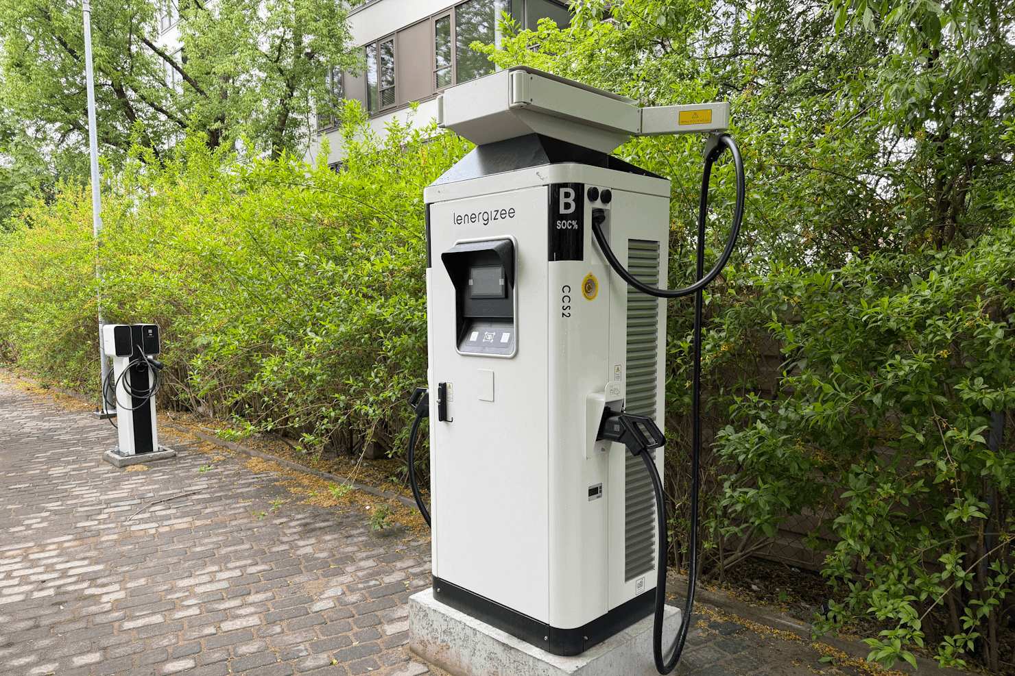 La borne de recharge rapide en courant continu Lenergizee CCS2 située près du parking : un exemple du développement des infrastructures de recharge pour véhicules électriques en Pologne